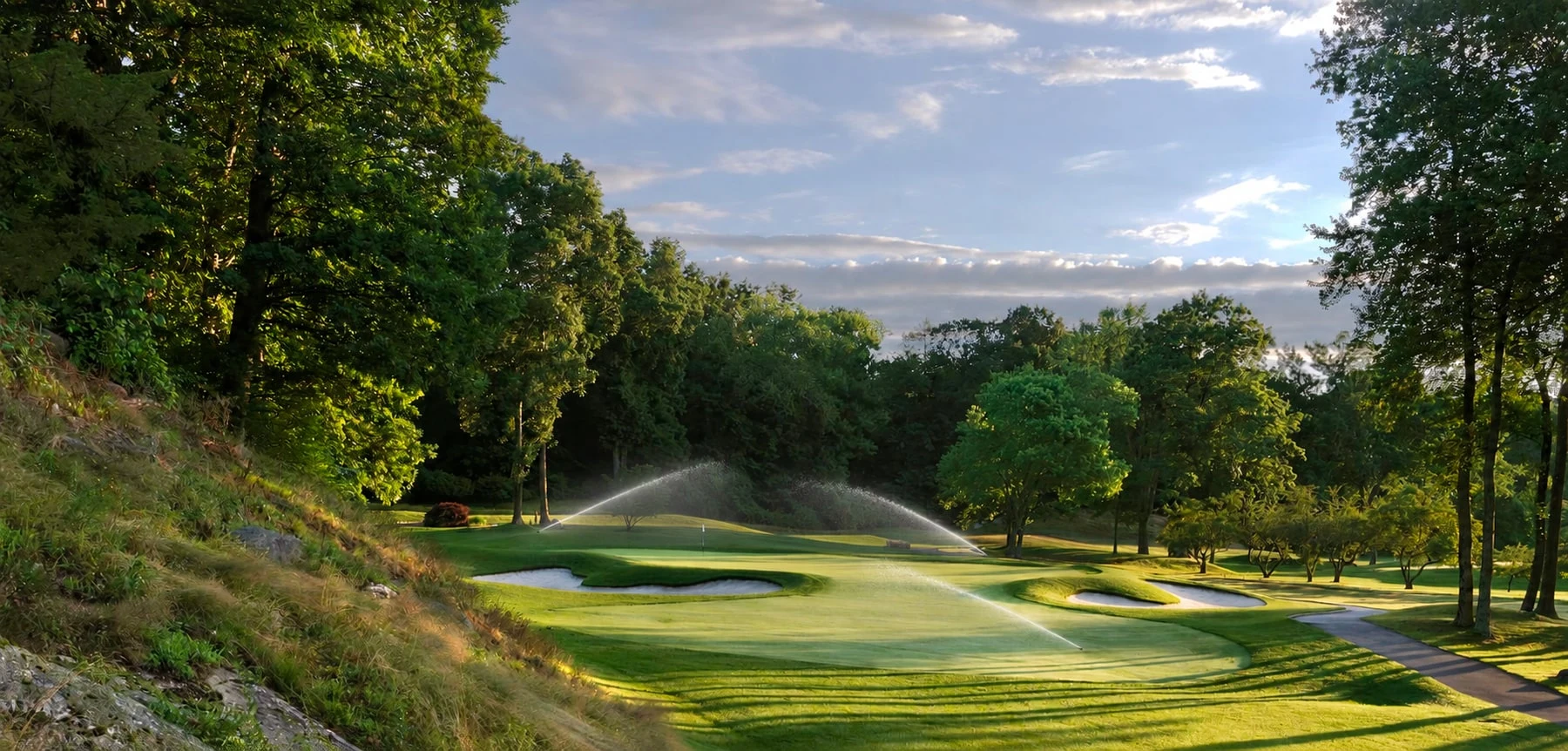 Irrigation along the wooded green at Burning Tree Country Club, with illustrative irrigation added.