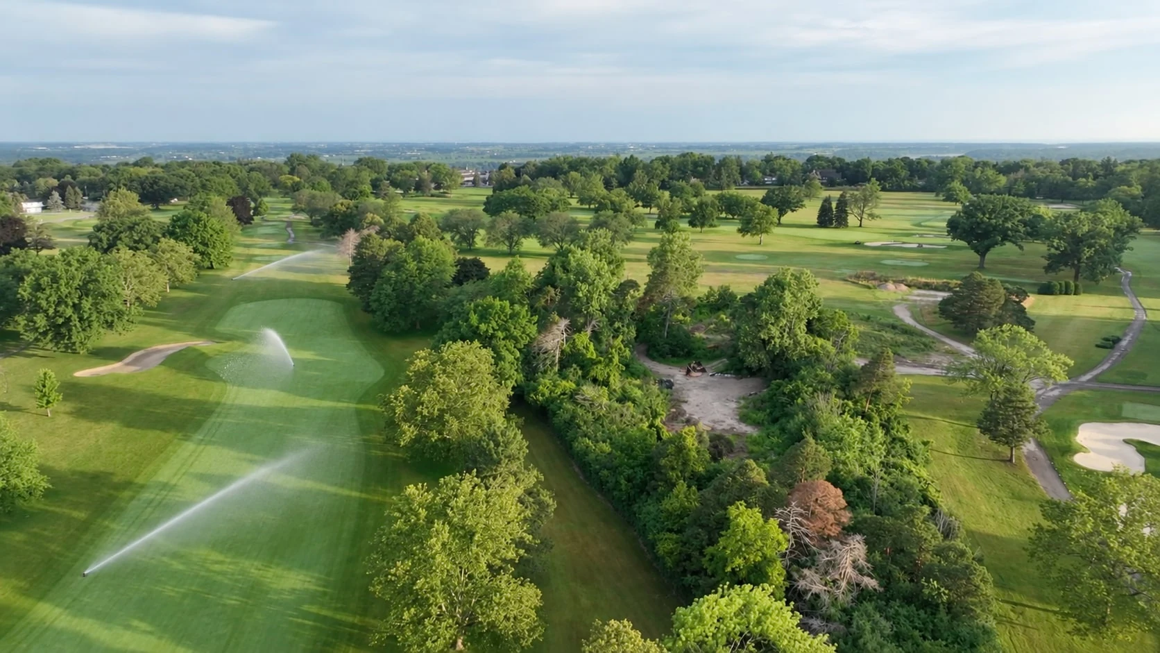 Aerial view of Niagara Falls Country Club with illustrative irrigation added at varied directions on the left-side turf.