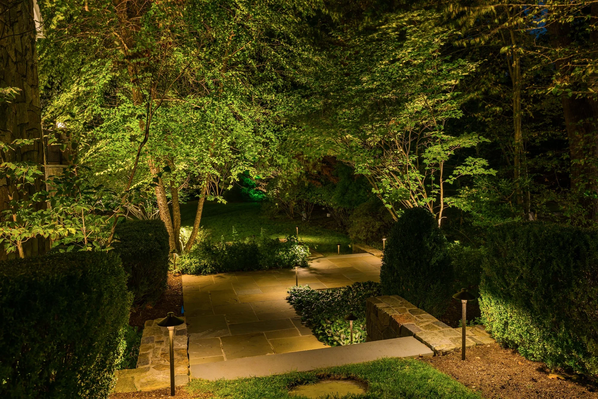 A lit stone walkway winds through the planting at Beauty in Briarcliff.