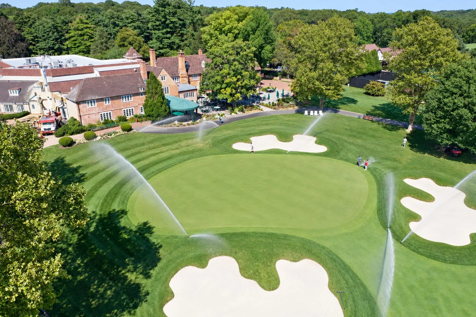 An aerial view of irrigation running beside the clubhouse at Mill River Club.