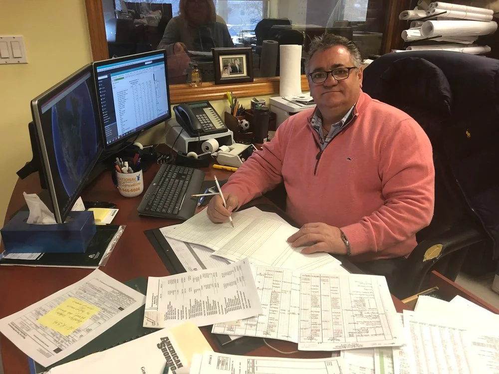 John Luciano at his desk in the National Lawn office.