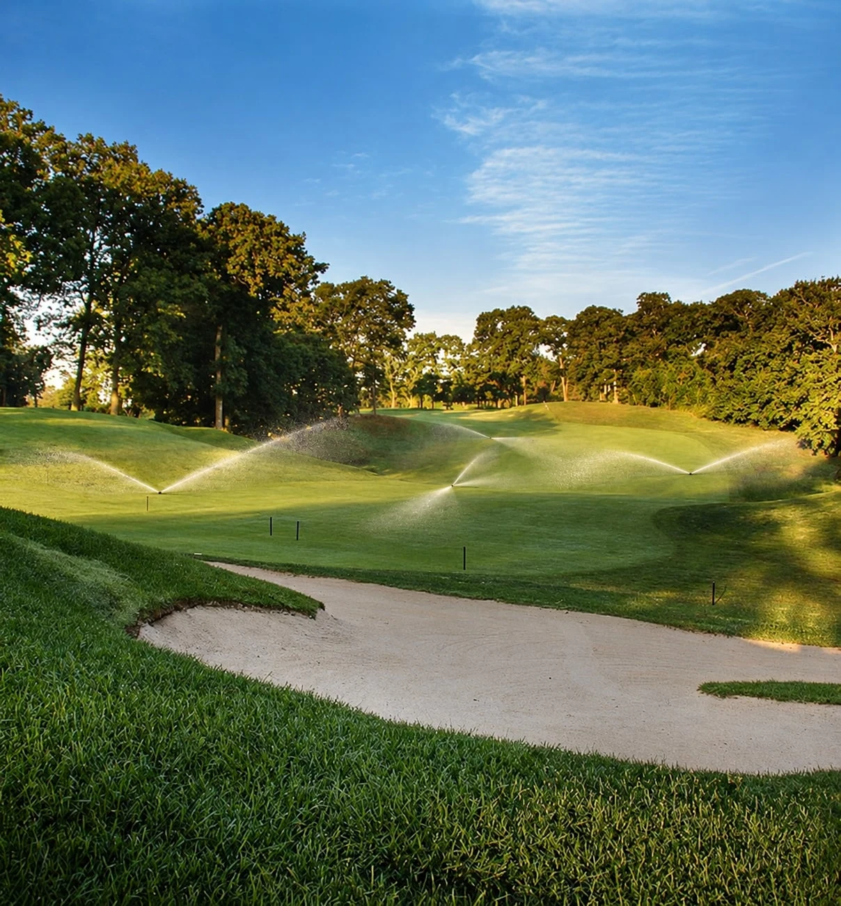 AI-edited view over a Nissequogue bunker and rolling fairway, with irrigation added.